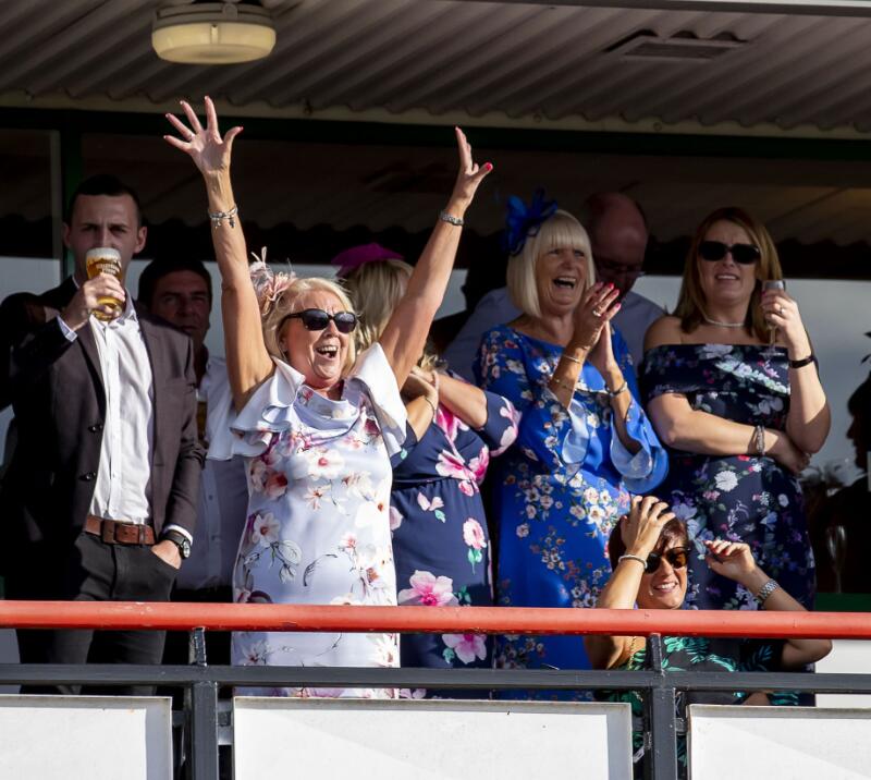 Hospitality guests cheer on the balcony at Wolverhampton
