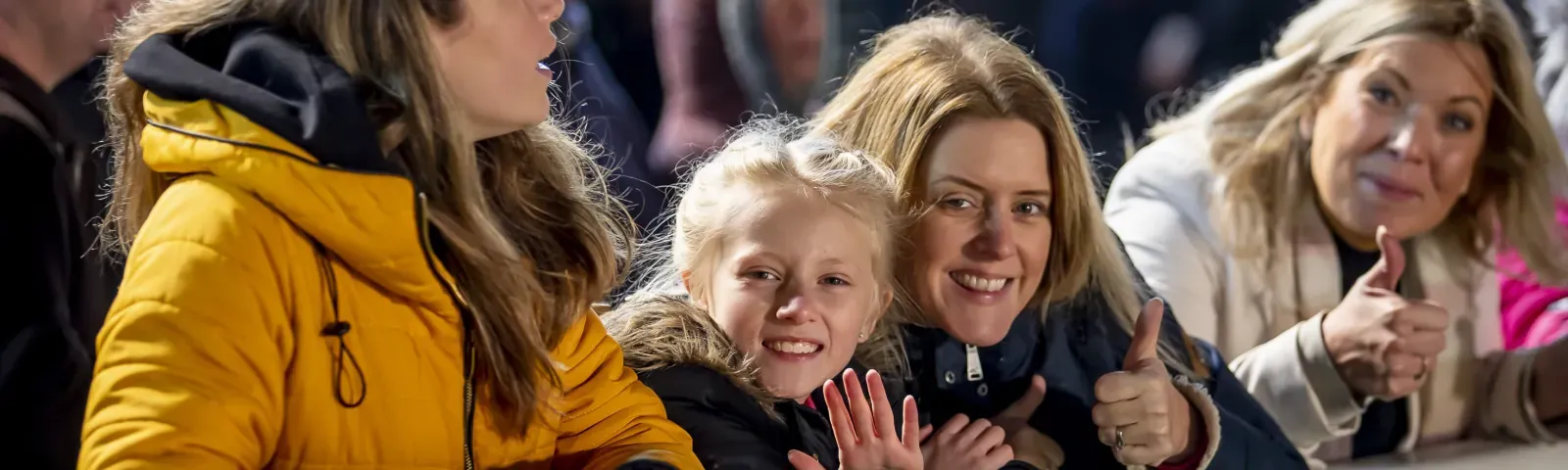 A family at the trackside at Wolverhampton Races give a thumbs up for the camera