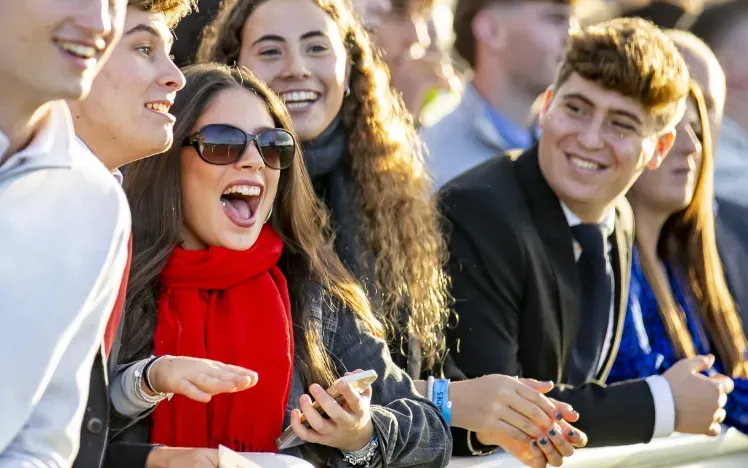 A group of young racegoers watch from the trackside at Wolverhampton Races