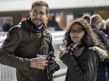 A couple wrapped up for the weather enjoy a drink at Wolverhampton Racecourse