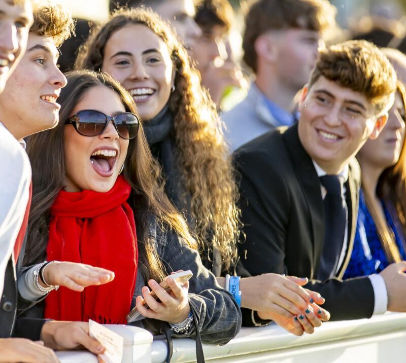 A young group of race goers laugh together at Wolverhampton Races