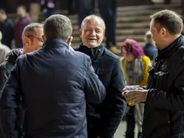 A group of gents wrapped up for the weather have a chat at Wolverhampton Races