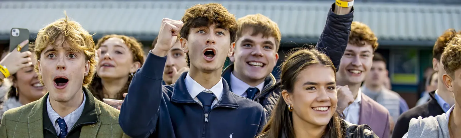 Young racegoers to Wolverhampton Racecourse pull shocked faces at the racing