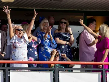 Hospitality guests at Wolverhampton Races cheer for the winner