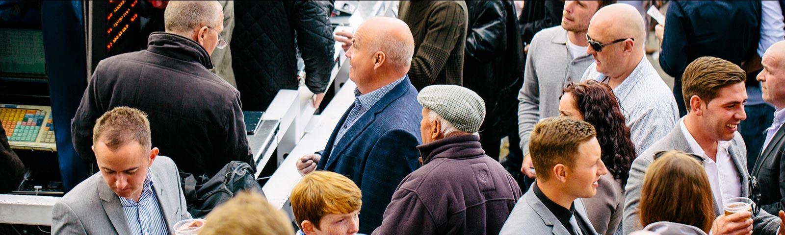 Crowds gathering around bookmakers.