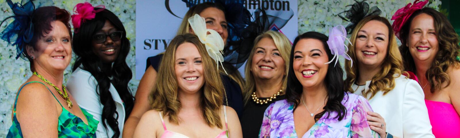 A group of women in colourful dresses at Wolverhampton Racecourse