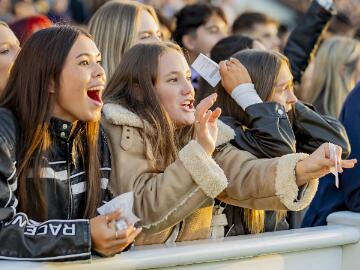 A group of young race goers cheer at Wolverhampton Races